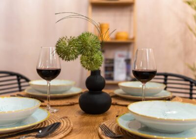 Stylish dining table setup with elegant tableware and wine glasses – Astoria Loft Apartment in Budapest