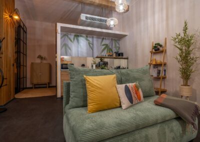 Cozy green sofa and modern open kitchen area in Astoria Loft Apartment – Budapest city center rental